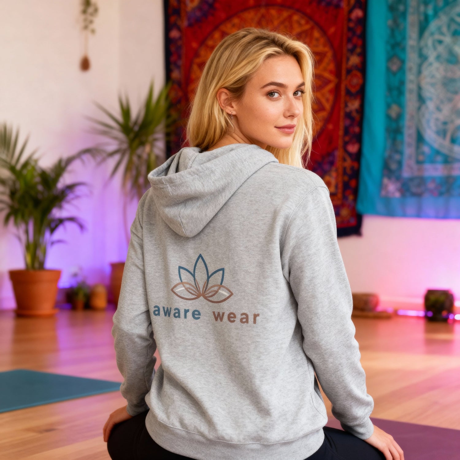 girl wearing a grey hoodie with Aware wear brand print